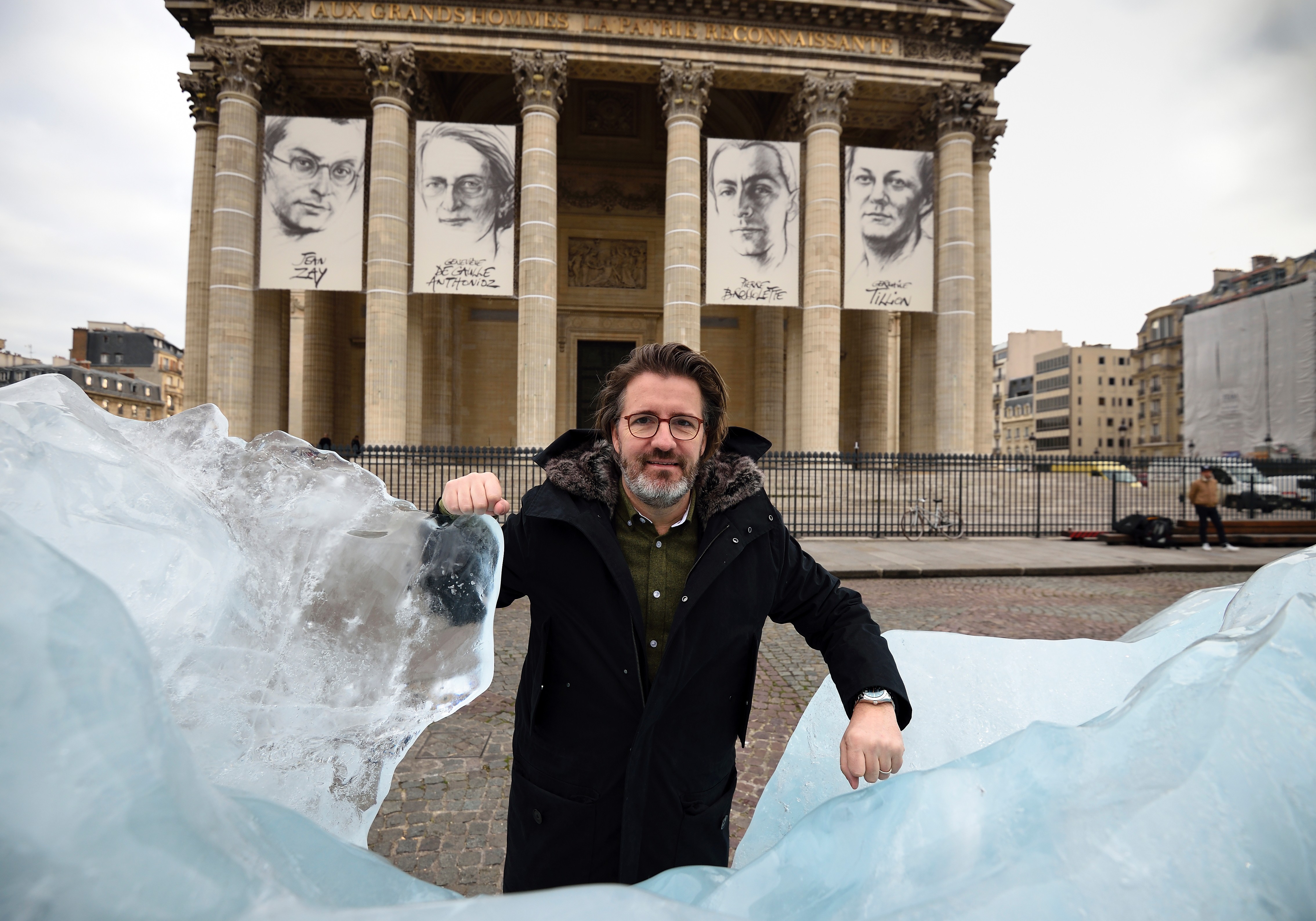 Danish-Icelandic artist Olafur Eliasson poses beside his art installation "Ice Watch" made with parts of Greenland's ice cap, on display in front of the Pantheon in Paris on December 3, 2015