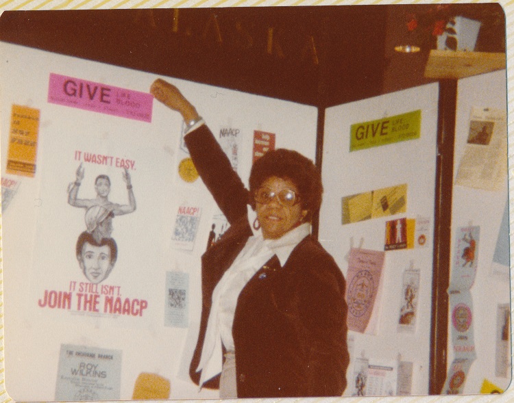 Pat Berkley with a display board for the Alaska Black Caucus, 1979