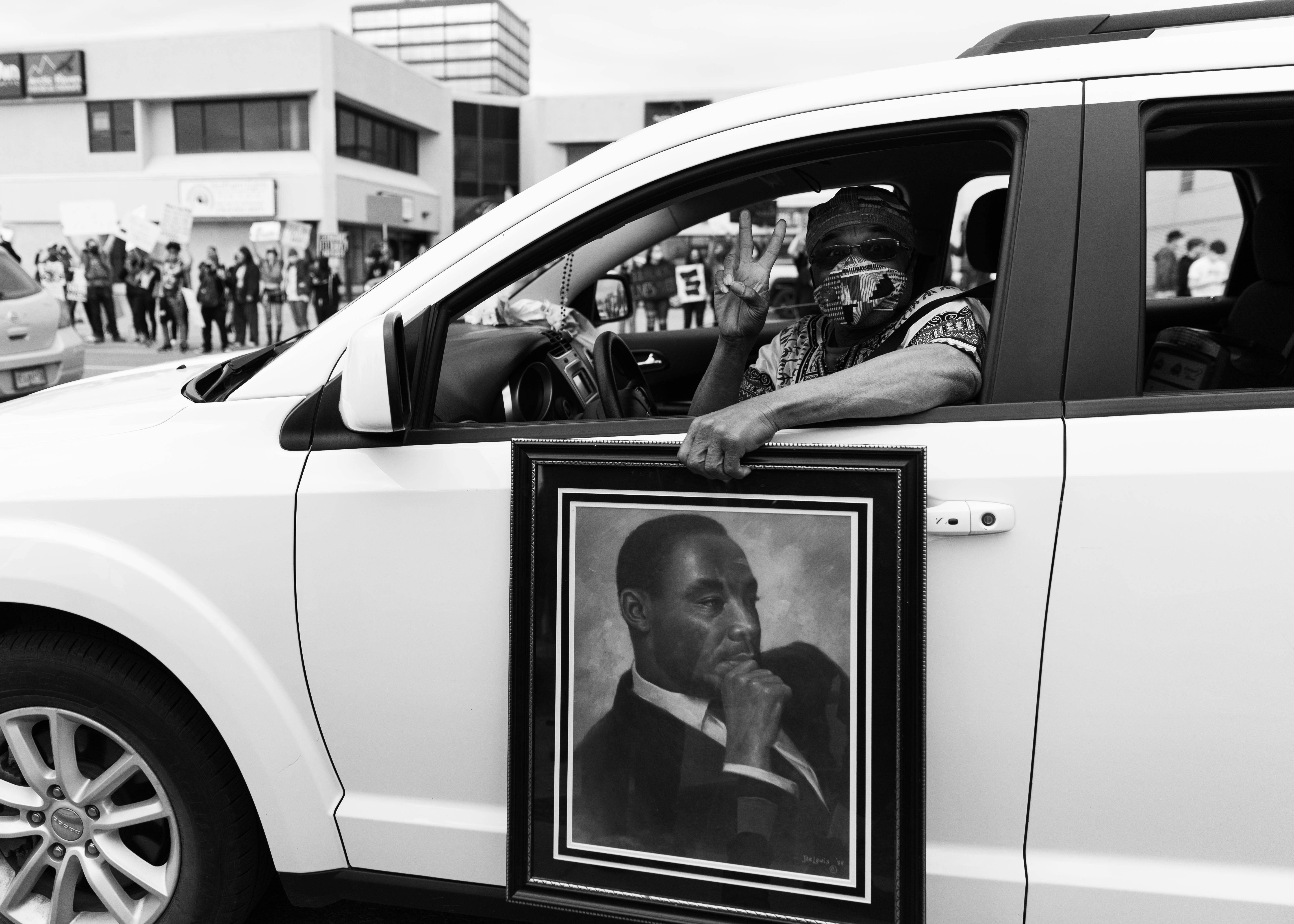 Cal Williams holding a portrait of Dr. Martin Luther King, Jr. at a Black Lives Matter rally, Anchorage, 2020