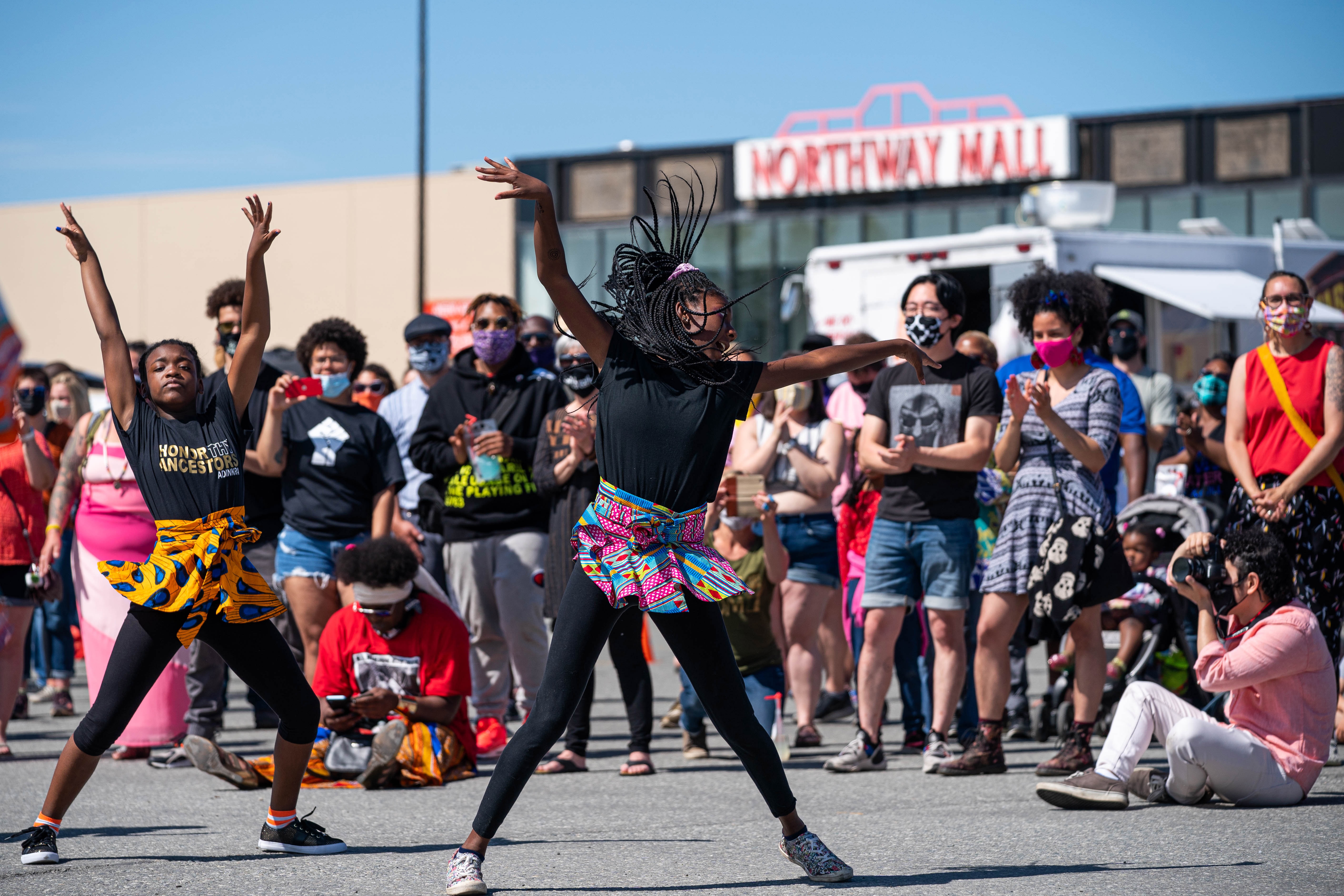 Nariyah Morgan, 9, and Janya Evans, 14, perform a dance with Sankofa Dance Theater at Juneteenth in Anchorage, 2020