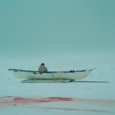 Man looking out over the lead in an umiak